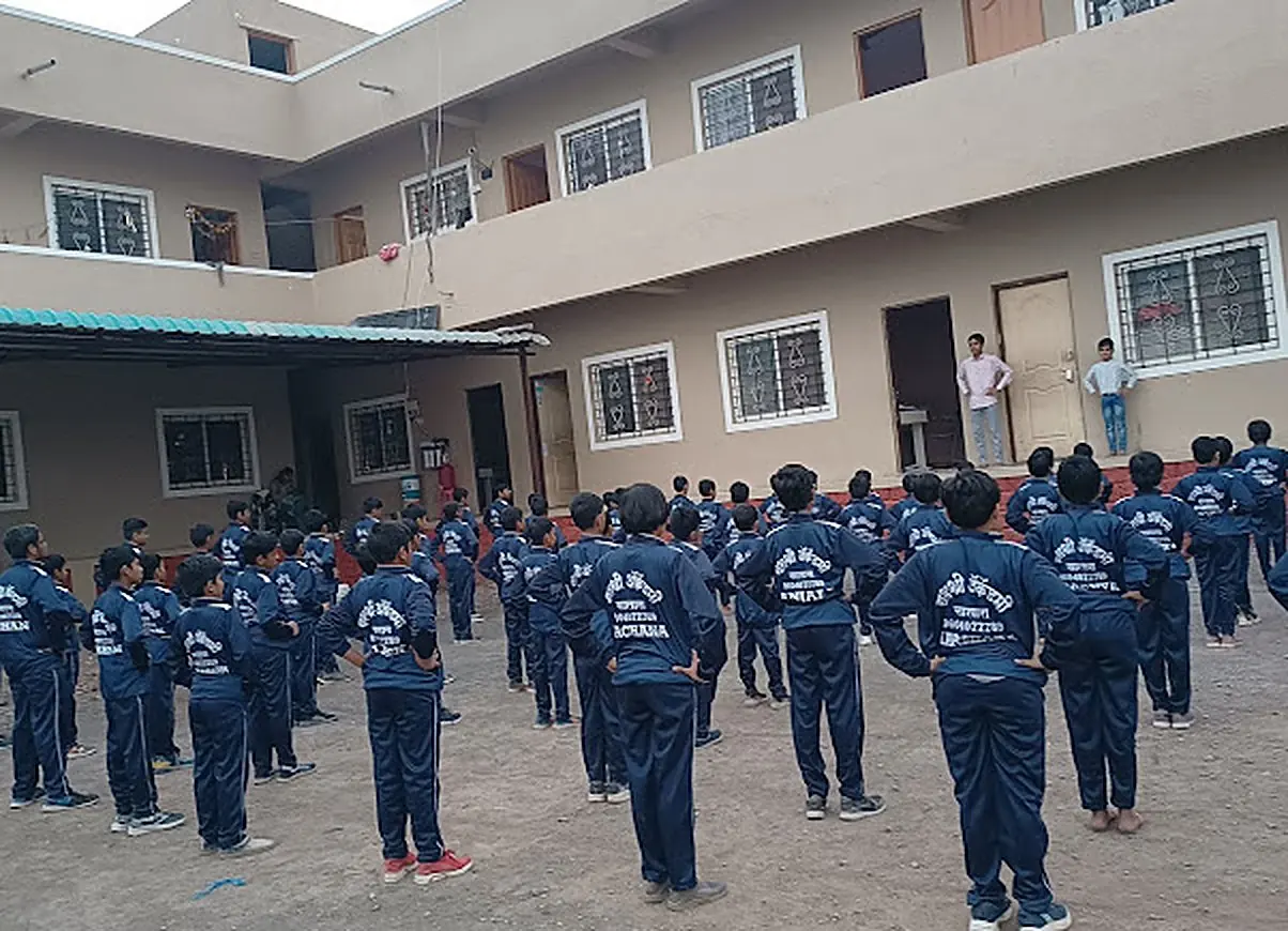 Students at morning exercise in front of the Yashashree Academy hostel building